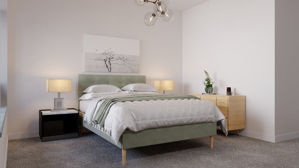 A green modern fabric bed frame in the middle of a room. 