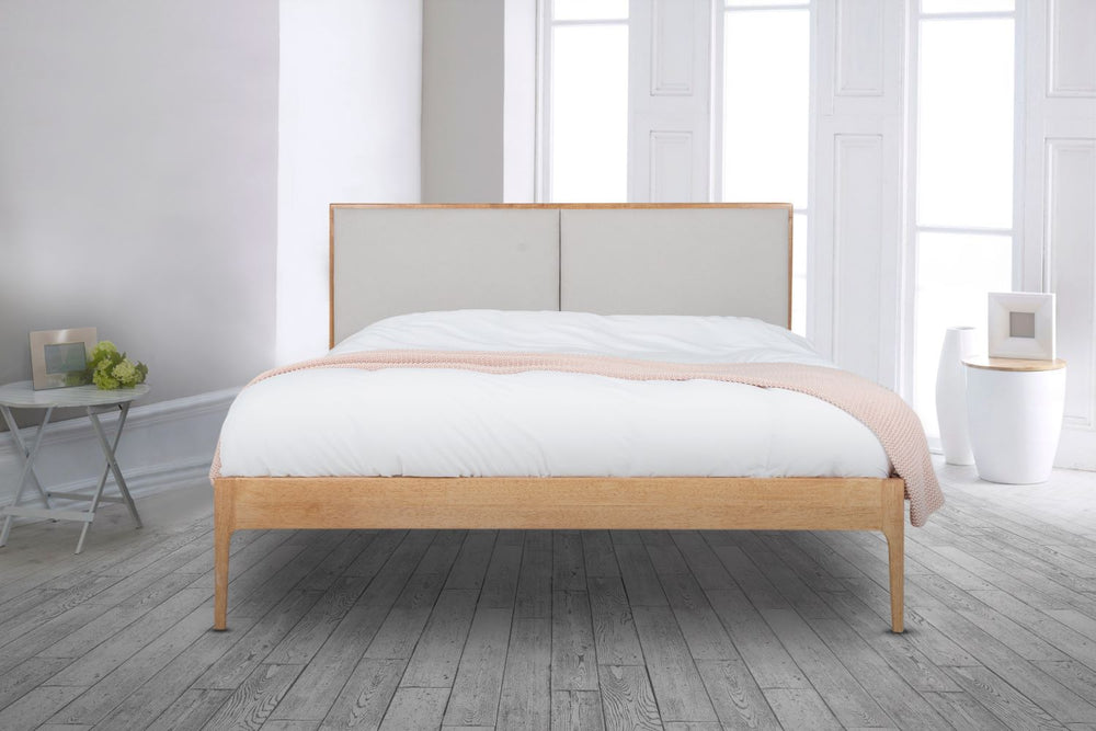 The Elegant Wooden Micah Wooden Bedframe joins Natural oak with an Upholstered headboard. With its minimalistic design creates a luxurious look with its fully upholstered headboard taking centre stage in any bedroom.