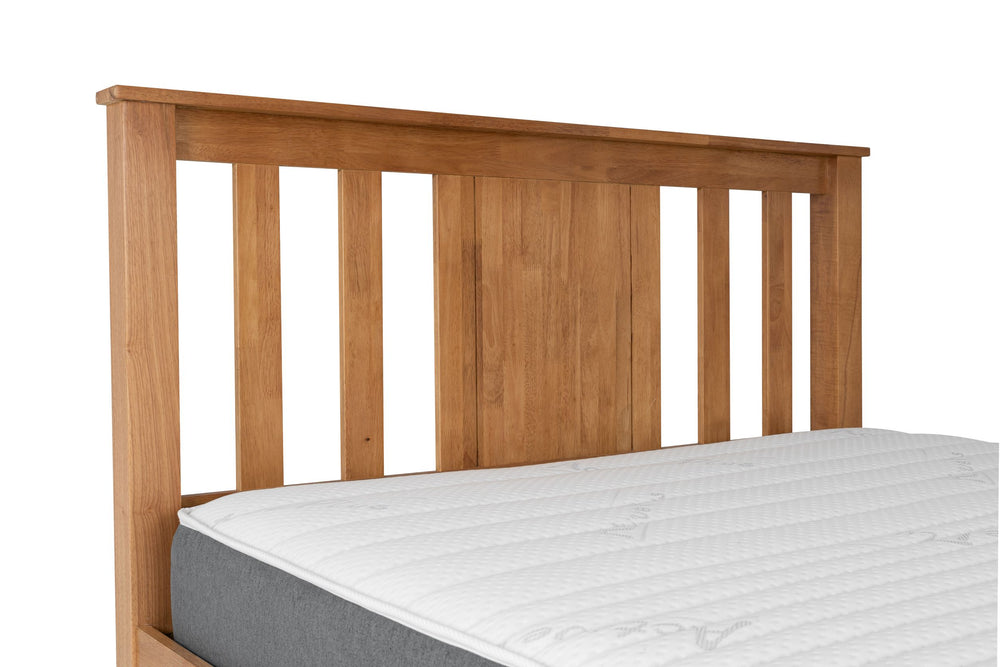 
                  
                    Close up of a wooden slatted head board. The top of a mattress can be seen on the bed frame. 
                  
                