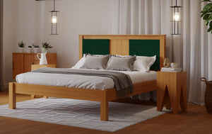 
                  
                    A wooden bed frame with a green fabric square either side of the head board. The room has a wooden floor and white walls. 
                  
                