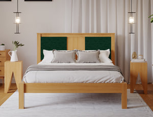 
                  
                    A wooden bed frame with an emerald green fabric square either side of the head board. The room has a wooden floor and white walls. 
                  
                